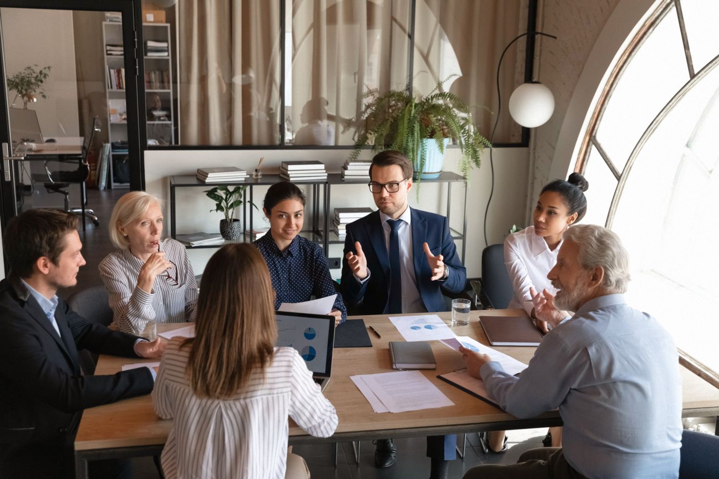Physicians and finance professionals in discussion around a meeting table